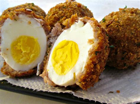Turn the oven on to 350F/180C. Once the temperature is almost reached start dipping the scotch eggs. Dip the egg in a bowl of flour to coat the sausage fully then dip it in the beaten egg and finally roll it into the breadcrumbs. Using a heatproof slotted spoon place one scotch egg in the pan at a time.